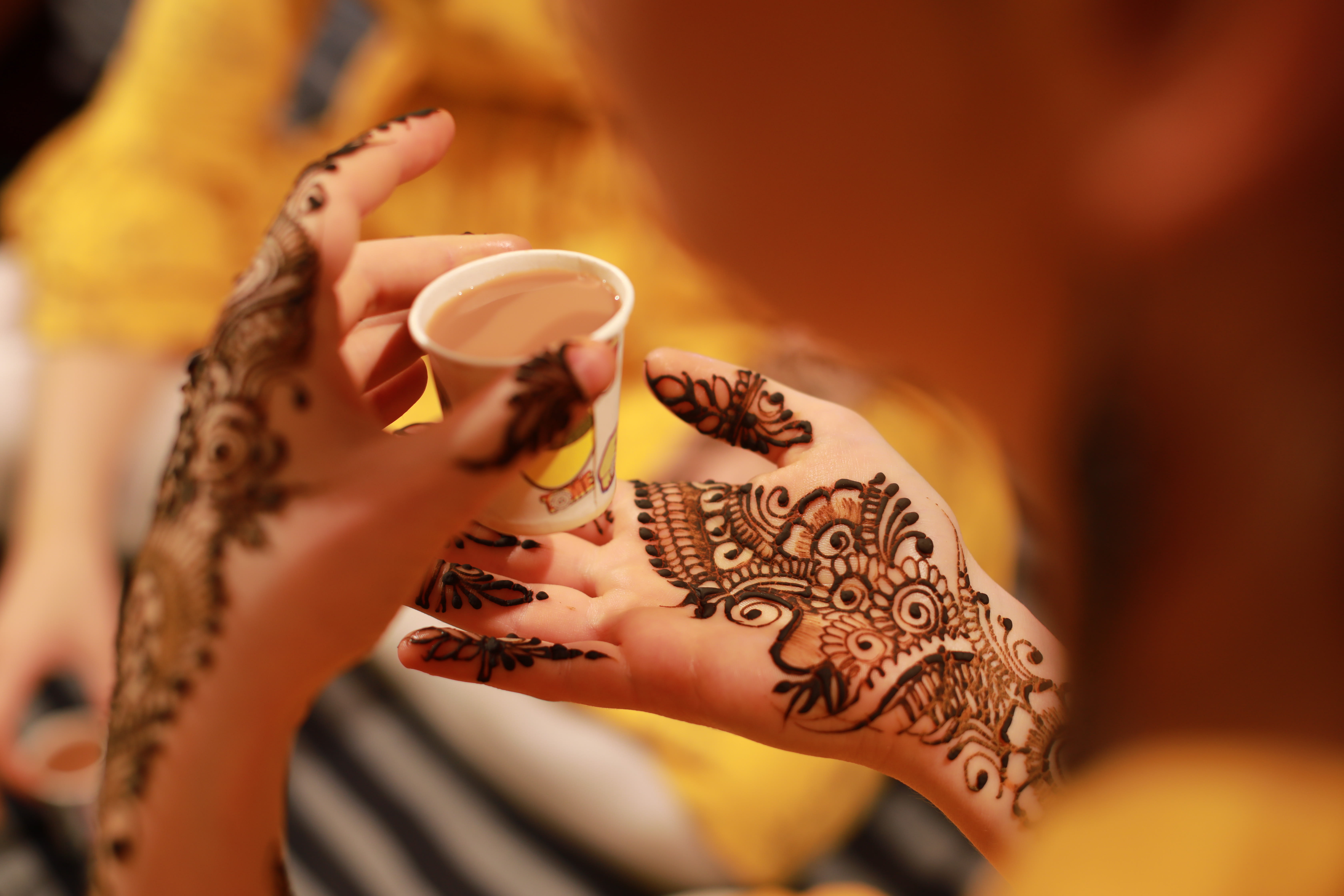 hand with henna and chai