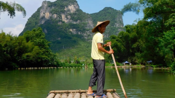 Cruising on a bamboo raft in Yangshuo, China (Image uploaded to Reddit by u/antisarcastics).