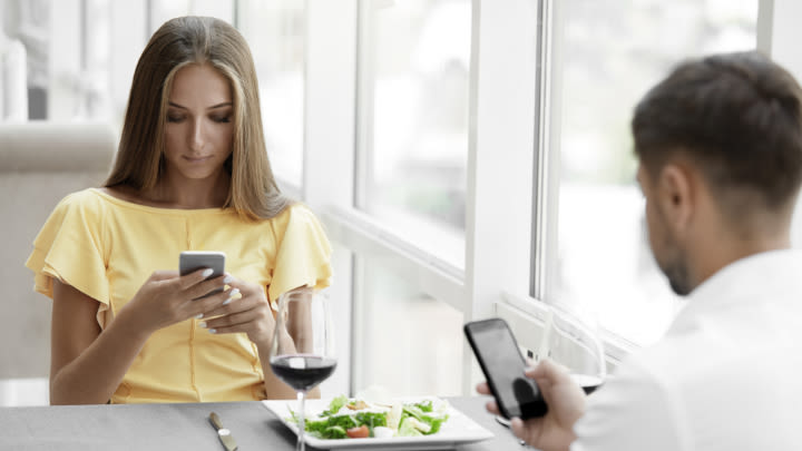 Putting your phone away while eating with someone is basic etiquette (Image: Shutterstock).