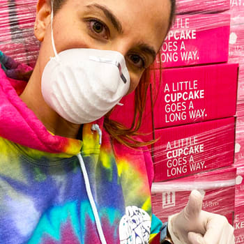 Melissa Ben-Ishay In a Tie-Dye Sweatshirt In Front of Pink Baked By Melissa Shipping Boxes Giving a Thumbs Up Melissa Ben-Ishay In a Tie-Dye Sweatshirt In Front of Pink Baked By Melissa Shipping Boxes Giving a Thumbs Up