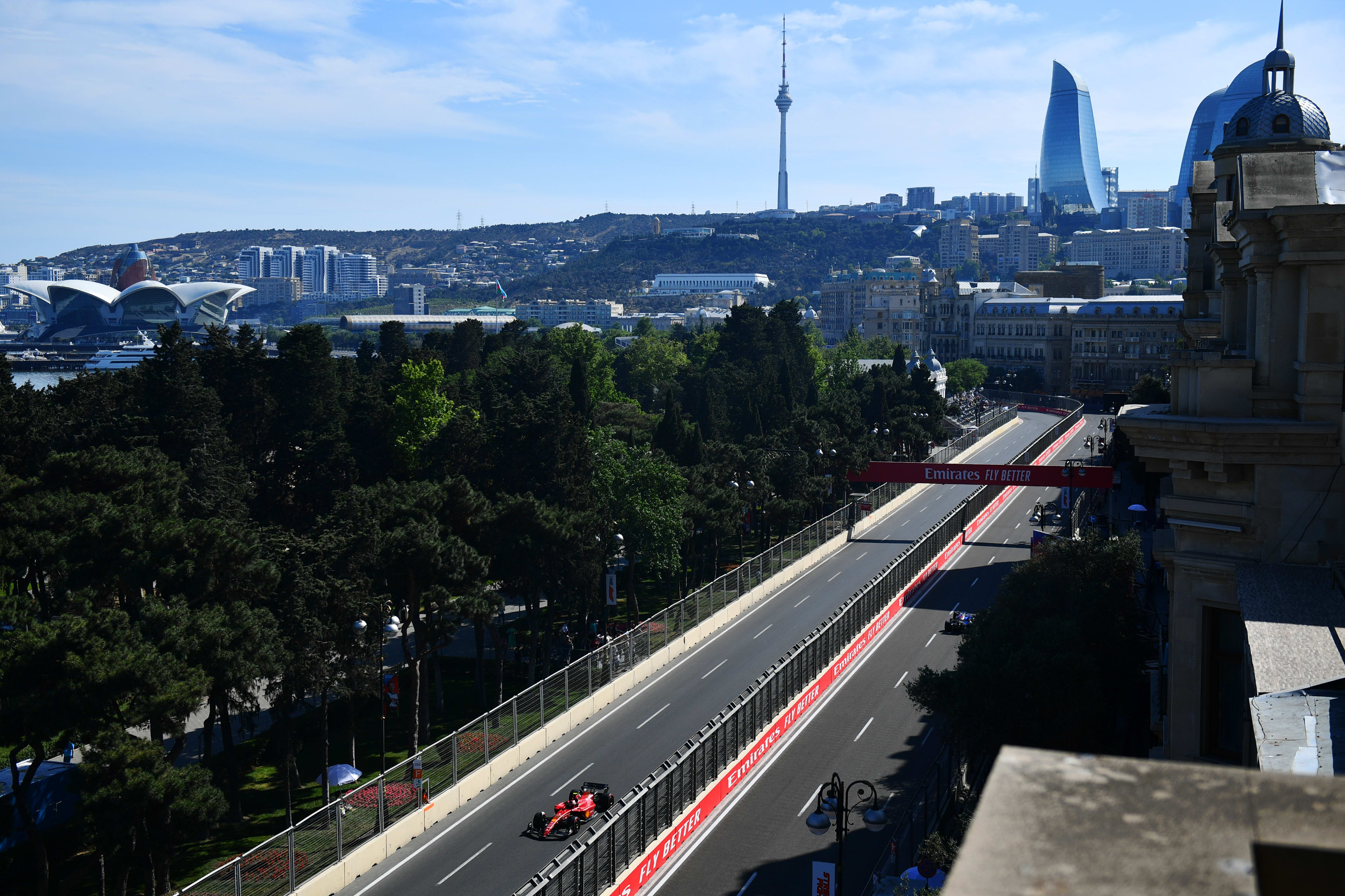 A Ferrari makes his way up the final straight to the start/ finish while a Williams passes by on the other side of the track
