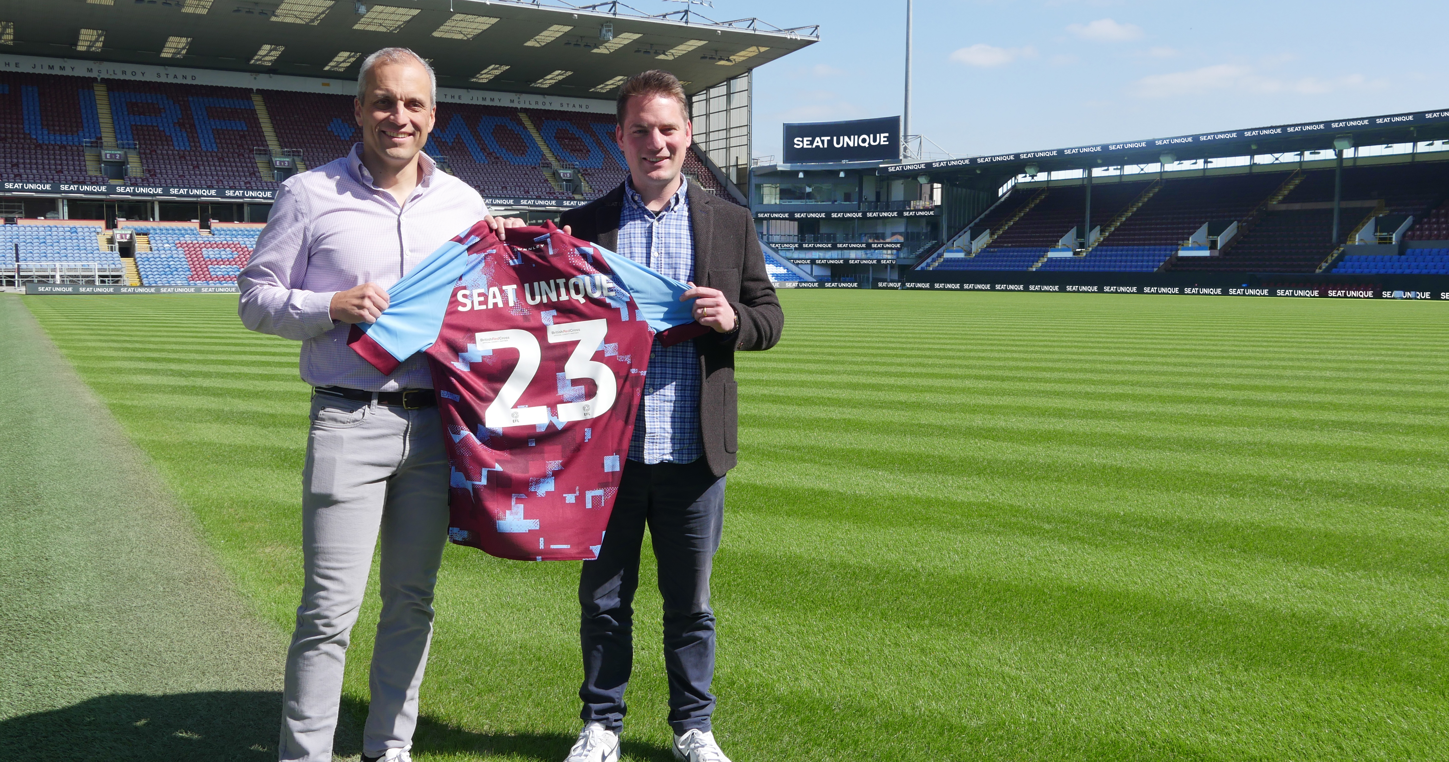Marcus Mellor, Head of Commercial at Burnley FC, and Matt Judge, Head of Commercial at Seat Unique holding Burnley shirt at T