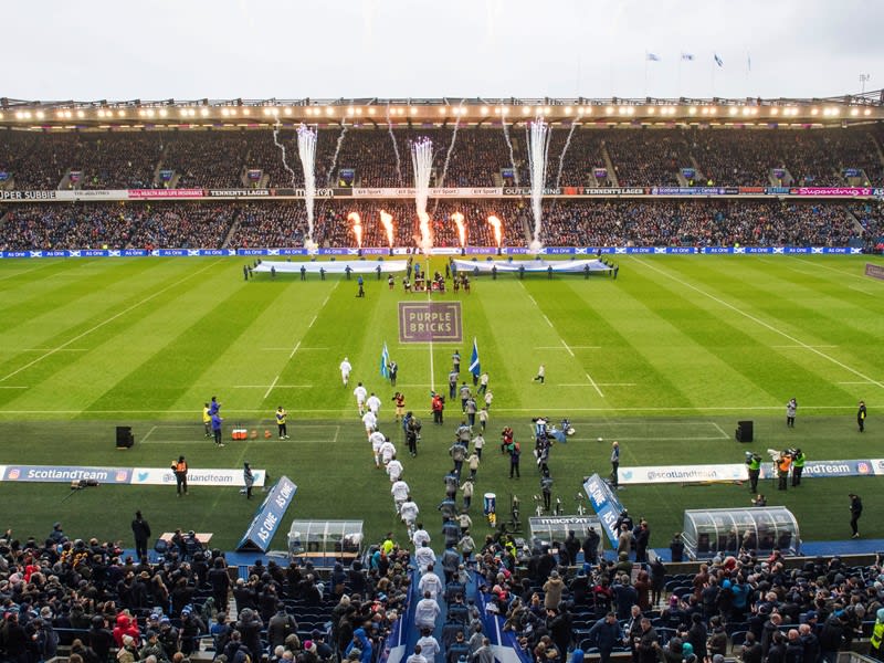 Scotland and their opponents emerge from the tunnel and take to the field.
