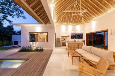 View onto the open air concept living area of Villa Lumahi Tiga at nightfall