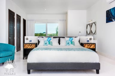 Villa Sandpiper's master bedroom with views of the Turtle Cove Marina.
