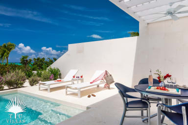 Villa Sandpiper's private pool with loungers and outdoor dining table.