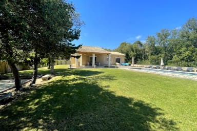 Garden with lawn area, petanque court and swimming pool