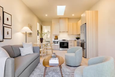 Seating area with sofa and lounge chairs.