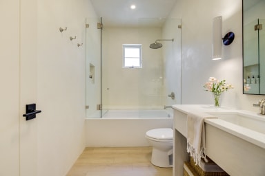 En-suite bathroom with combo tub rain shower and high-end toiletries