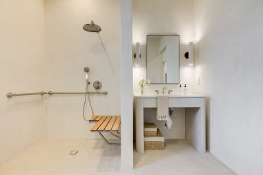 En-suite ADA bathroom with rain shower and high-end toiletries