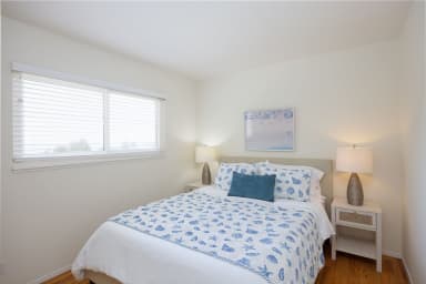 Sophisticated queen bedroom with natural light