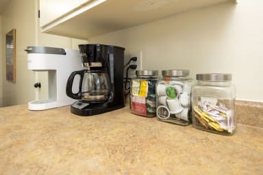 Convenient coffee nook with cups, maker.