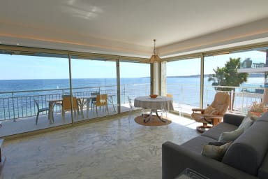 Living room with sofa bed, all opening onto a terrace with sea view