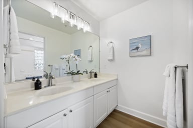Fully equipped bathroom with dual sinks and modern fixtures