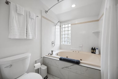 Elegant bathroom with bathtub, shower, and WC