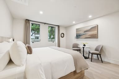 King-size bed, sleeps 2, seating area, and 65