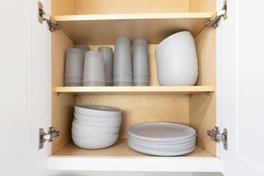 Well-stocked kitchen with cups, plates, and organized storage