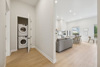 In-unit laundry room with a full-size washer and dryer.
