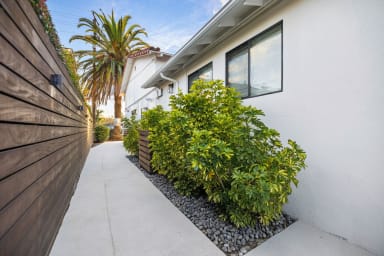 Gather in our cozy backyard retreat, illuminated by gentle, warm light.