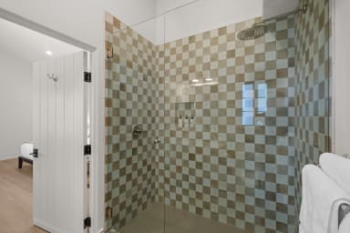 En-suite bathroom with rain shower and Public Goods toiletries.