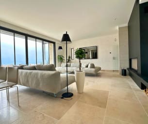 The lounge extends seamlessly onto the panoramic terrace.