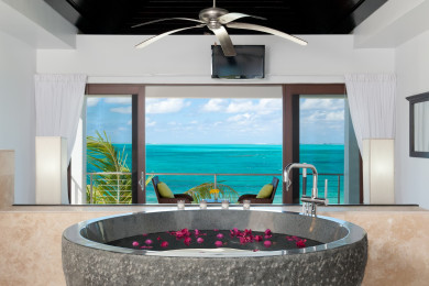En-suite bath with tub and beach views.