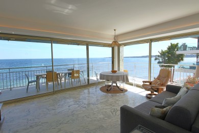 Living room with sofa bed, all opening onto a terrace with sea view