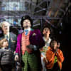 Douglas Hodge as Willy Wonka with Jack Costello as Charlie and cast members