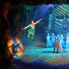 Peter Pan (Josh Andrews) flies off over the heads of the audience watched by other cast members
