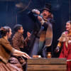 Adam Basset and Emma Prendergast as Bob and Mrs Cratchit with members of the Hull Truck young company