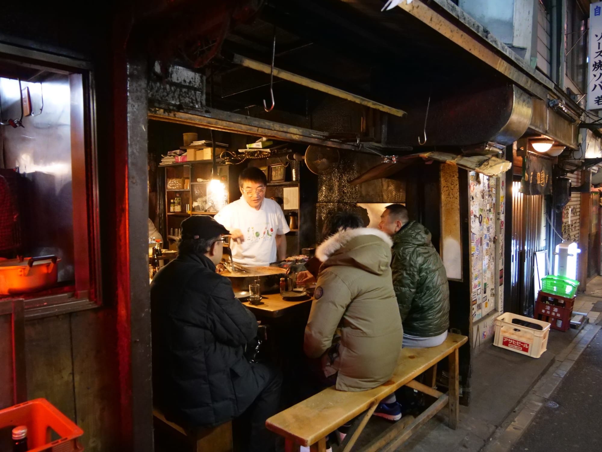 Locals drink at an izakaya after work