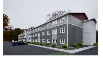 Perspective view of a contemporary three-story apartment complex with gray siding and white-trimmed windows, set against a cloudy sky and surrounded by greenery.