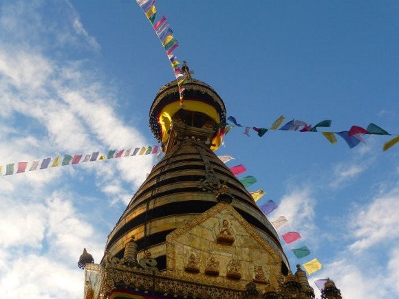 Buddhist prayer flags fluttering atop a temple
