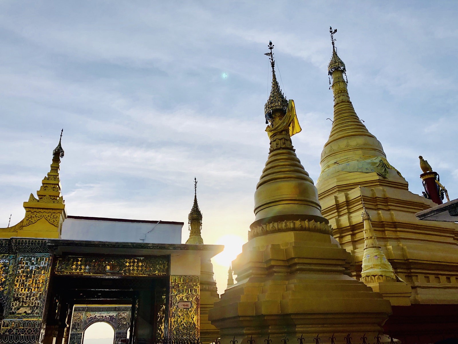 Myanmar_Golden pagodas on top of Mandalay Hill with sun setting in the background