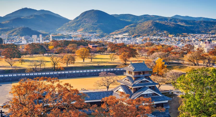Enchanting Travels Japan Tours Kumamoto Castle Turret and the landscape of Kumamoto, Japan in autumn