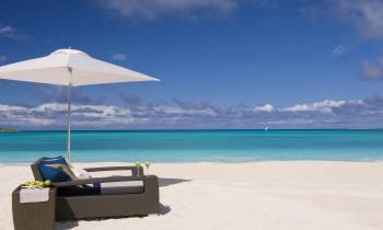 an umbrella sitting on top of a beach