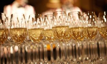 a row of wine glasses on a table
