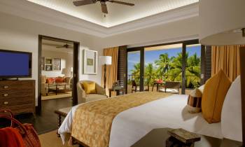 a hotel room filled with furniture and a flat screen tv