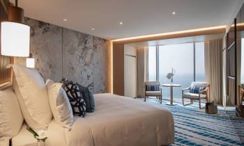 a bedroom with a large bed in a hotel room