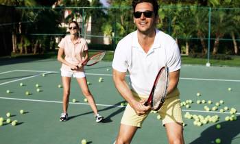 a man holding a racket on a court