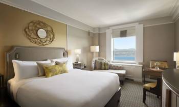 a bedroom with a large bed in a hotel room