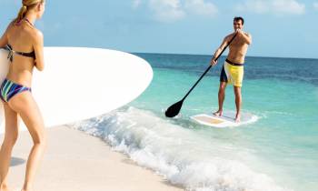 a person in a swimsuit walking on a beach