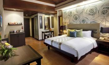 a bedroom with a bed and desk in a room