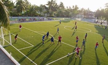 a group of people playing football on a field