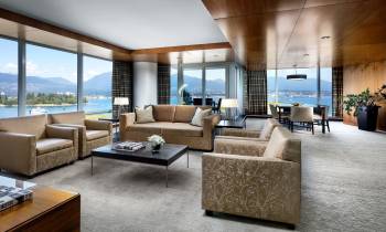 a view of a living room filled with furniture and a large window