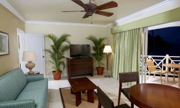 a living room filled with furniture and a dining table
