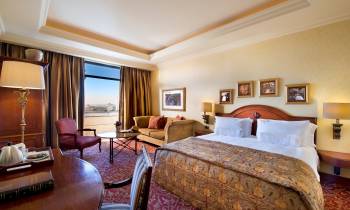 a bedroom with a large bed in a hotel room