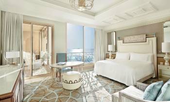 a bedroom with a bed and a mirror in a room