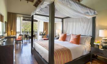 a bedroom with a large bed in a hotel room