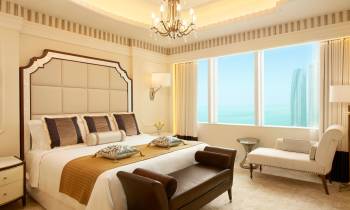 a hotel room filled with furniture and a large window